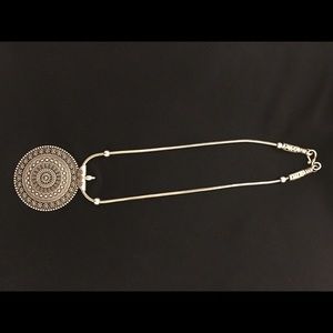 Silver colored pendant necklace. Made in India.